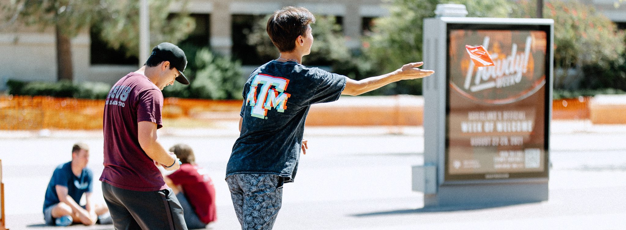 Texas A&M students playing cornhole at a Howdy Week event